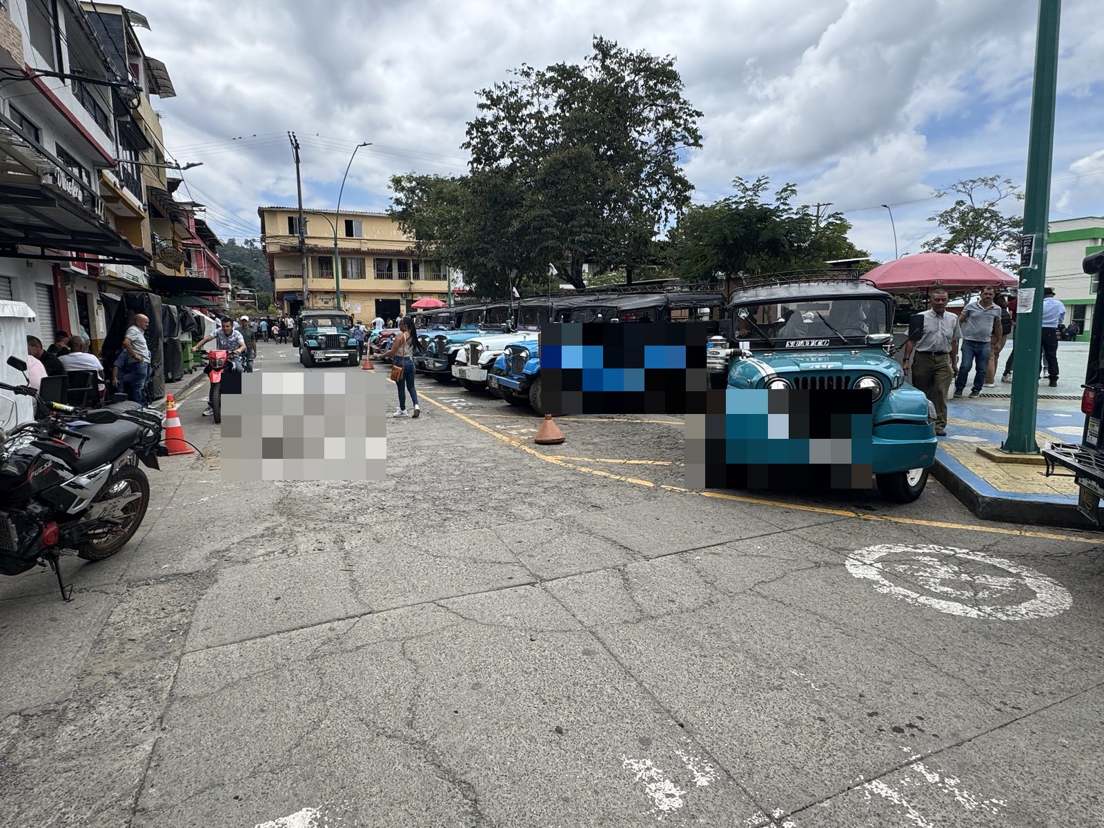 The central plaza of a coffee-region town with its classic jeeps